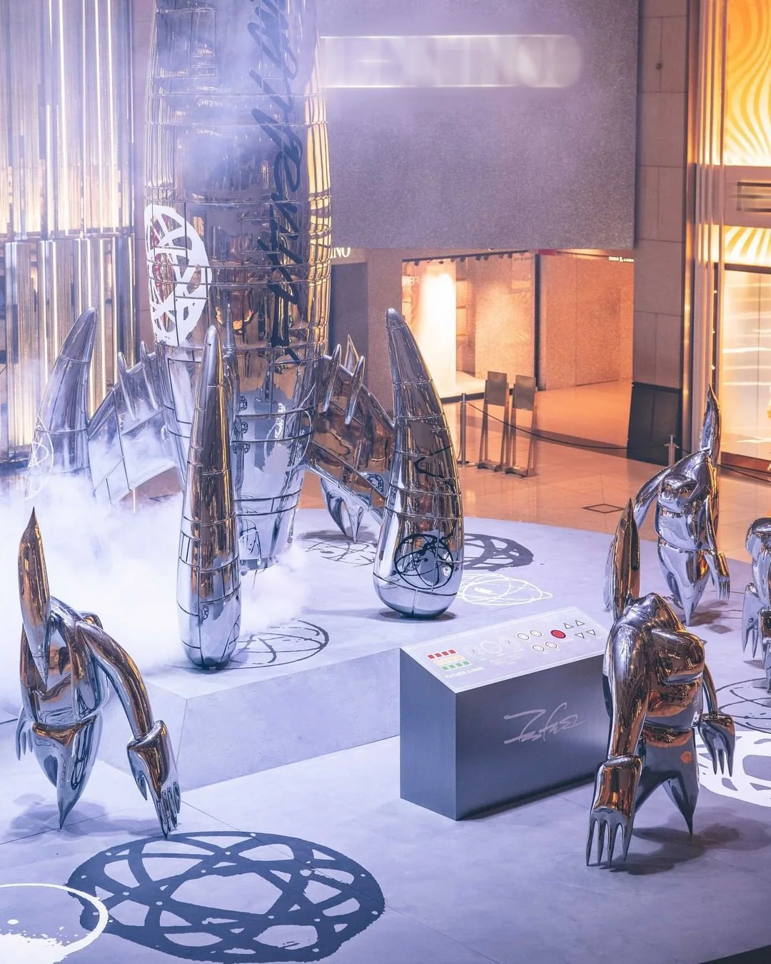 Installation view, FUTURALAND, 2021. Figures advancing from the rocket, with the signed control console.